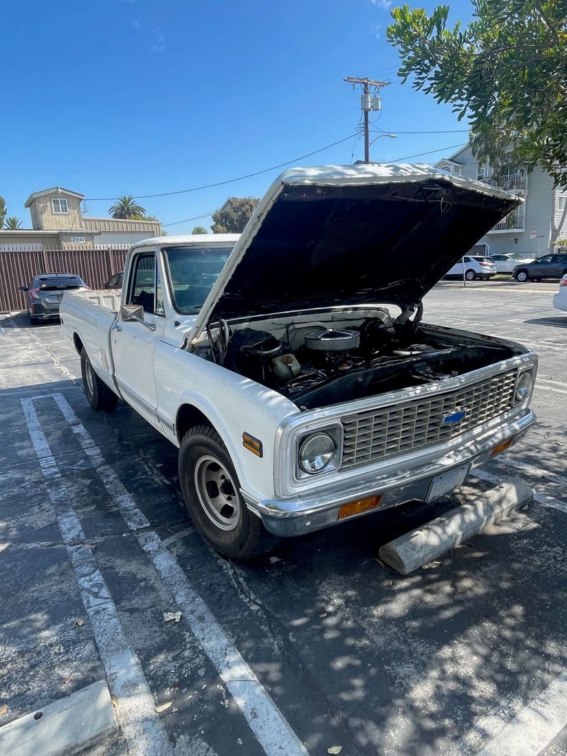 Engine bay of a classic Chevrolet C10 with the hood open