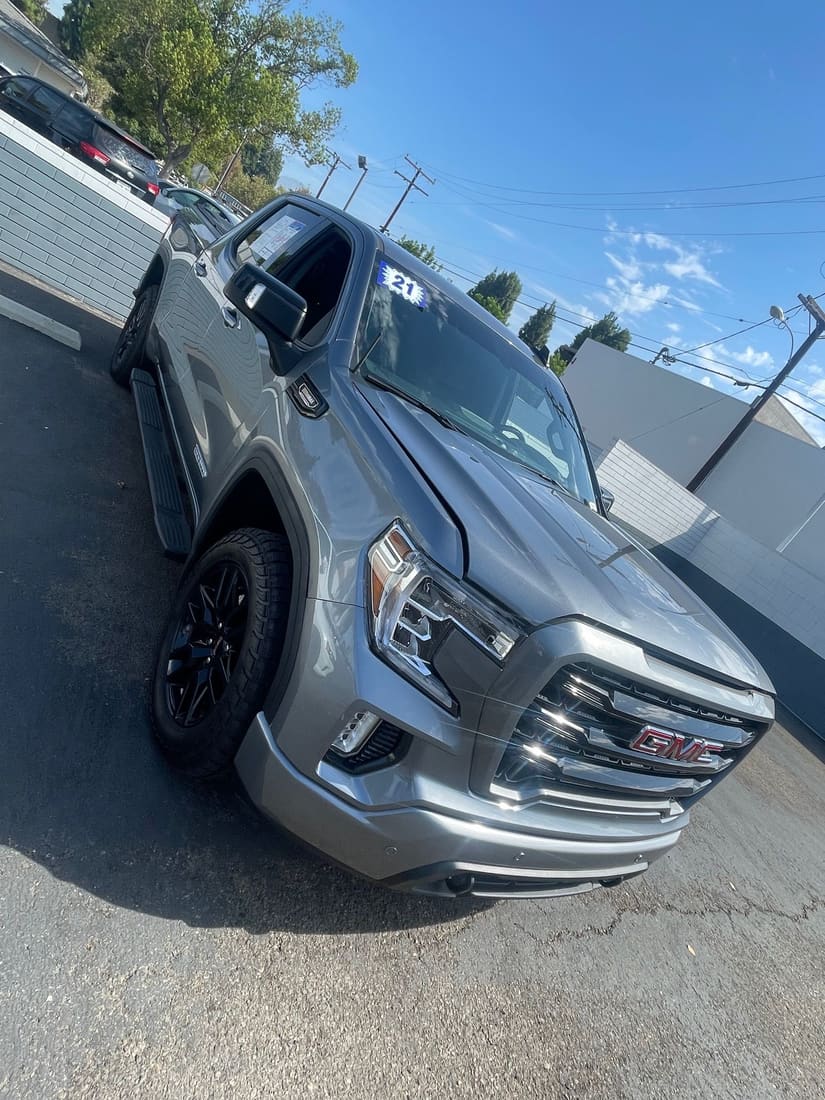 Gray GMC Sierra pickup on a used-car lot