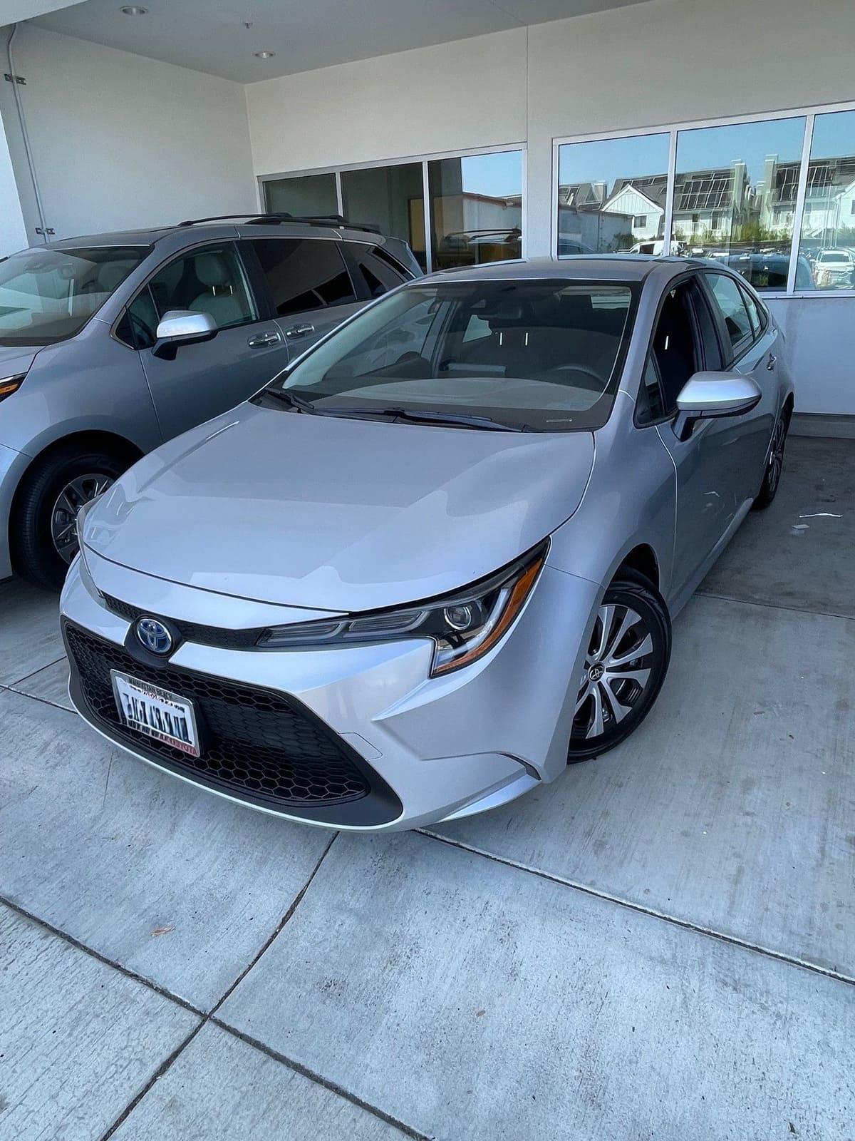 Silver Toyota Corolla Hybrid on a dealership lot